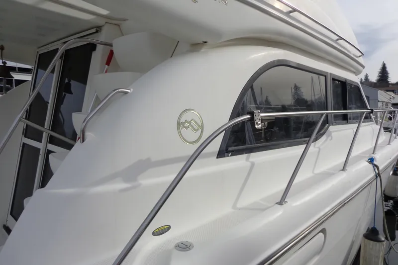 Slide: The Image of 2001 Bayliner 3488 Command Bridge Motoryacht docked, showcasing sleek design and windows. - 15