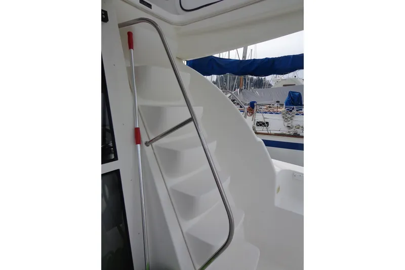 Slide: The Image of Staircase on 2001 Bayliner 3488 Command Bridge Motoryacht, featuring sleek design and marina view. - 18