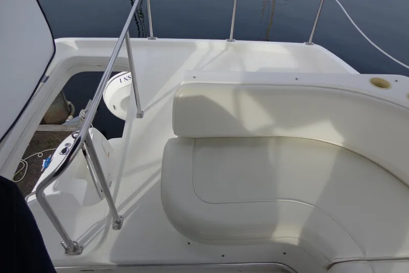 Slide: The Image of 2001 Bayliner 3488 Command Bridge Motoryacht seating area with white upholstery and railing. - 29