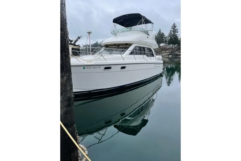Slide: The Image of 2001 Bayliner 3488 Command Bridge Motoryacht docked at a marina. - 3