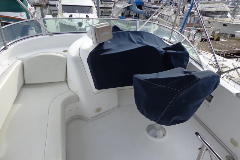 Slide: The Image of 2001 Bayliner 3488 Command Bridge Motoryacht helm with covered seats and controls. - 32
