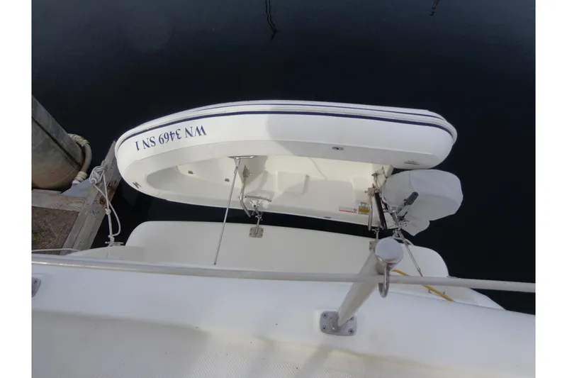 Slide: The Image of 2001 Bayliner 3488 Command Bridge Motoryacht with attached dinghy at dock. - 33