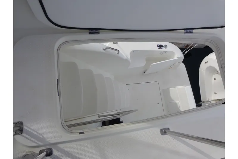 Slide: The Image of 2001 Bayliner 3488 Command Bridge Motoryacht interior view with white seating and hatch. - 34