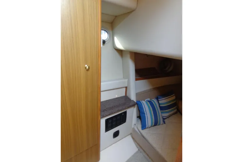 Slide: The Image of 2001 Bayliner 3488 Command Bridge Motoryacht interior with cozy cabin and striped pillows. - 46