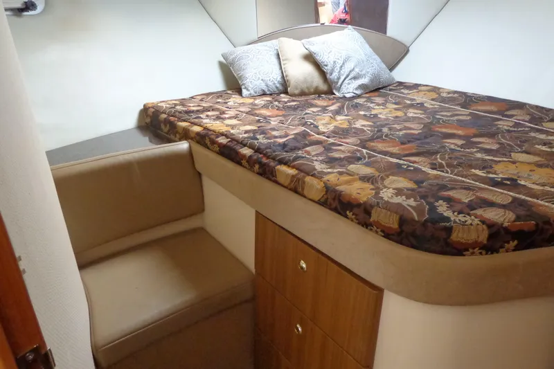 Slide: The Image of Cozy cabin interior of 2001 Bayliner 3488 Command Bridge Motoryacht with patterned bedding. - 50