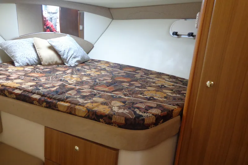 Slide: The Image of Luxurious cabin interior of 2001 Bayliner 3488 Command Bridge Motoryacht with patterned bedding. - 51