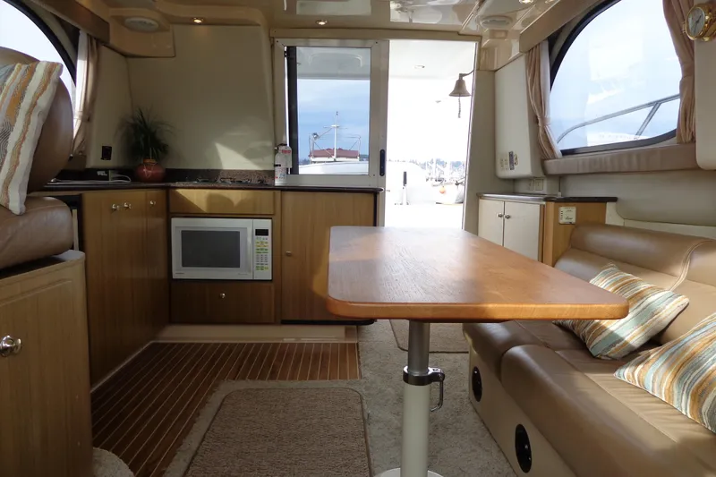 Slide: The Image of Interior of 2001 Bayliner 3488 Command Bridge Motoryacht with dining area and kitchenette. - 53