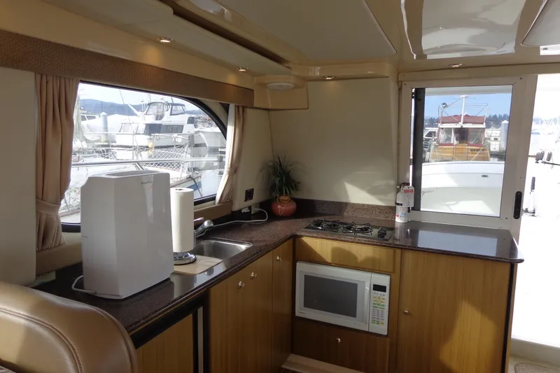 Slide: The Image of Interior of 2001 Bayliner 3488 Command Bridge Motoryacht kitchen with appliances and window view. - 55