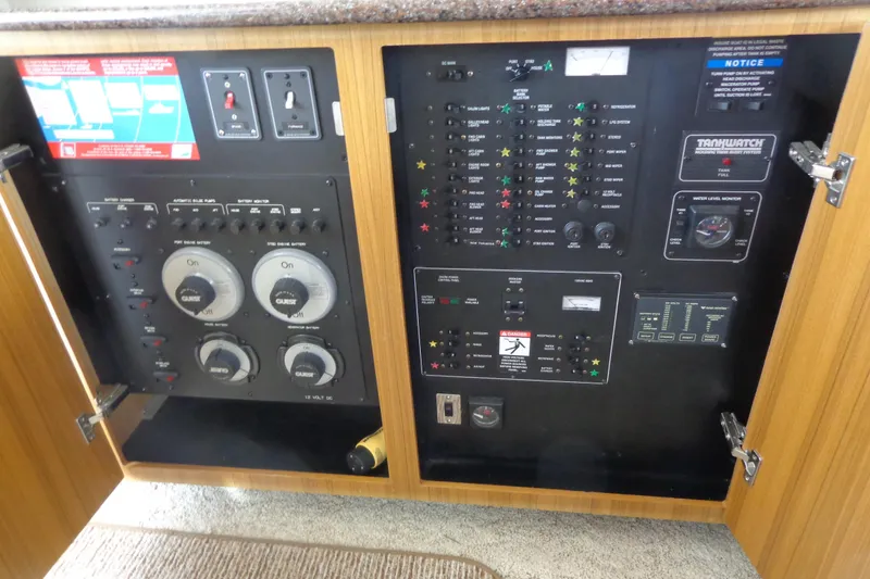 Slide: The Image of Control panel of a 2001 Bayliner 3488 Command Bridge Motoryacht, featuring various switches and gauges. - 57