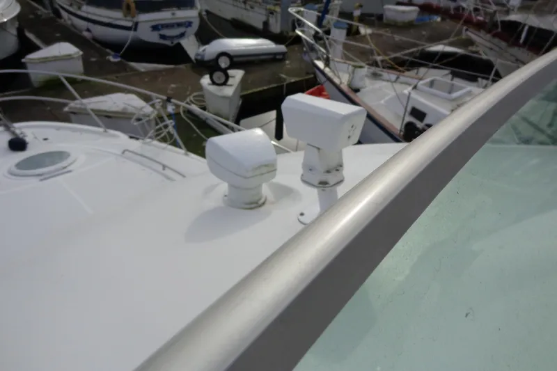 Slide: The Image of 2001 Bayliner 3488 Command Bridge Motoryacht radar equipment on deck, docked at marina. - 63