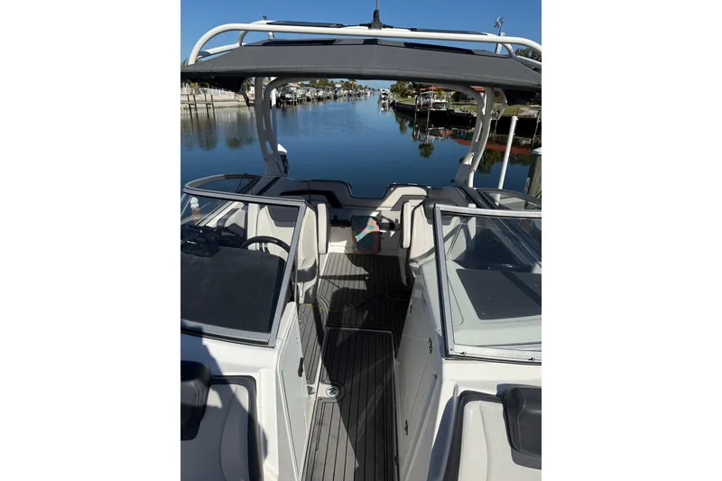 Slide: The Image of 2017 Yamaha Boats 242 Limited S E-Series on calm water, showcasing sleek interior design. - 23