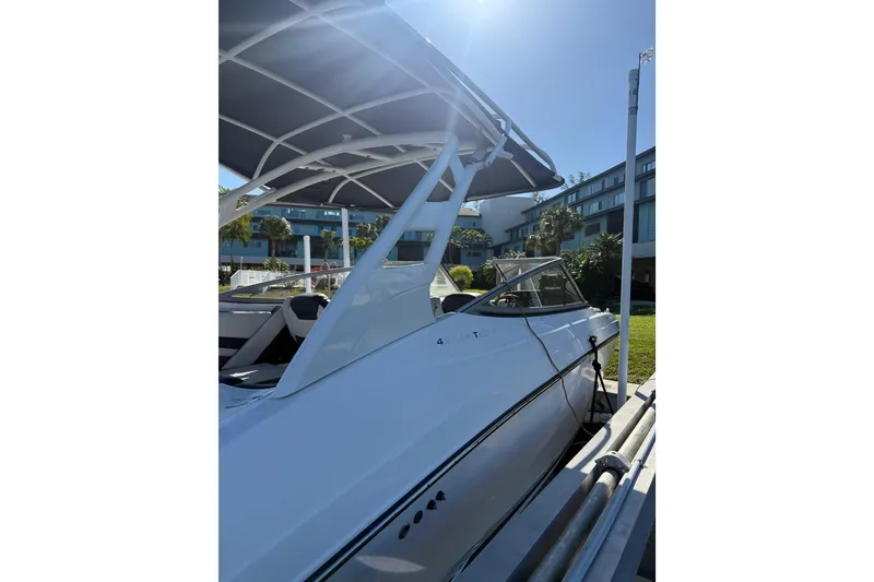 Slide: The Image of 2017 Yamaha Boats 242 Limited S E-Series docked under a canopy. - 29