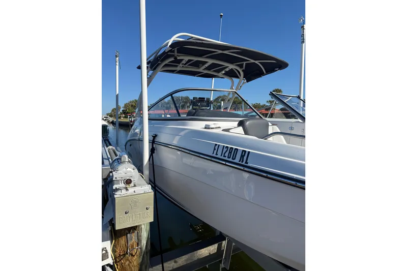 Slide: The Image of 2017 Yamaha Boats 242 Limited S E-Series docked, featuring sleek design and canopy. - 4