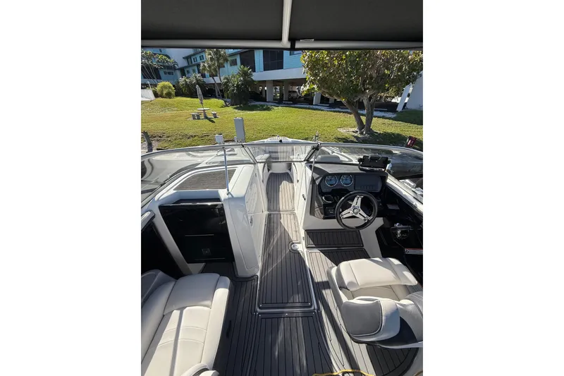 Slide: The Image of 2017 Yamaha Boats 242 Limited S E-Series interior with steering wheel and seating. - 5