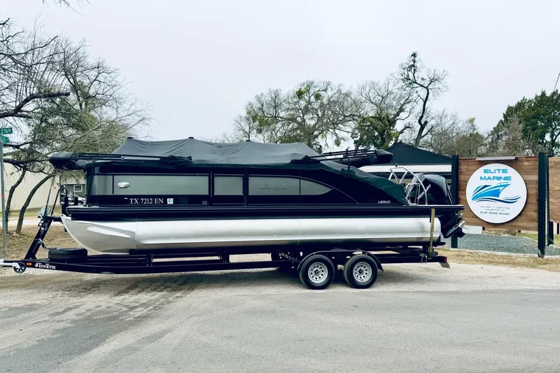 The Image of 2019 Barletta L23UC pontoon boat on trailer at Elite Marine dealership. - 1