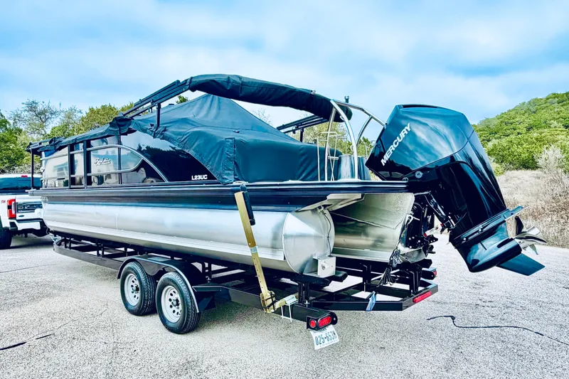 Slide: The Image of 2019 Barletta L23UC pontoon boat with Mercury engine on trailer. - 10