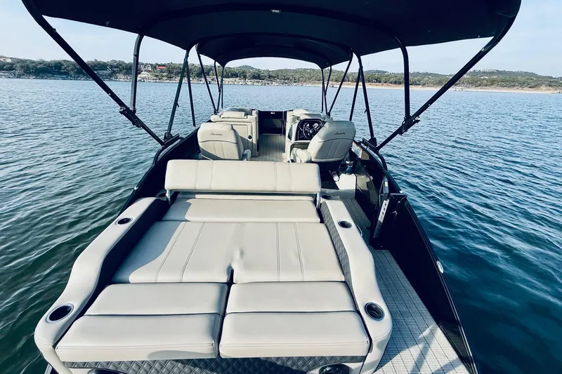 Slide: The Image of 2019 Barletta L23UC pontoon boat with spacious seating on a serene lake. - 16