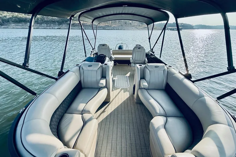 Slide: The Image of 2019 Barletta L23UC pontoon boat interior with luxurious seating on a serene lake. - 17