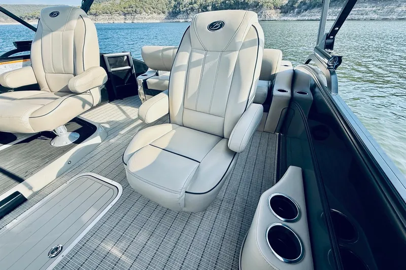 Slide: The Image of Luxurious interior of 2019 Barletta L23UC pontoon boat with plush seating and cup holders. - 23