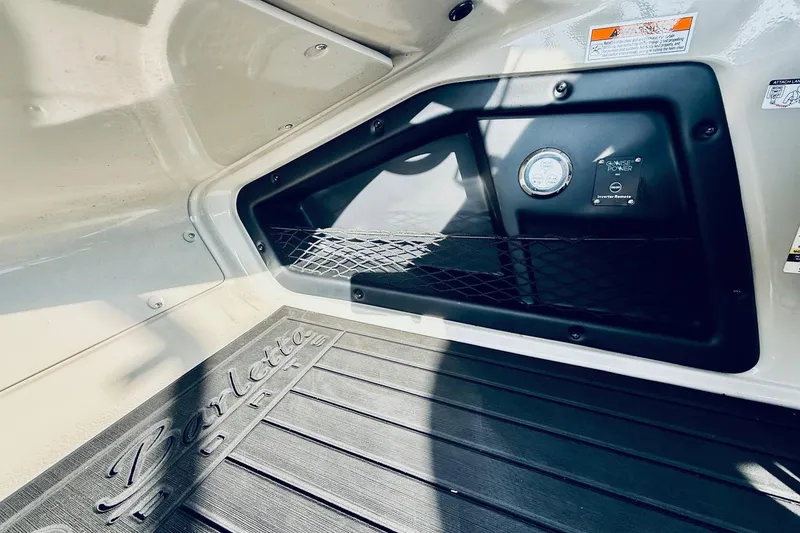 Slide: The Image of 2019 Barletta L23UC boat interior with storage compartment and branded flooring. - 25