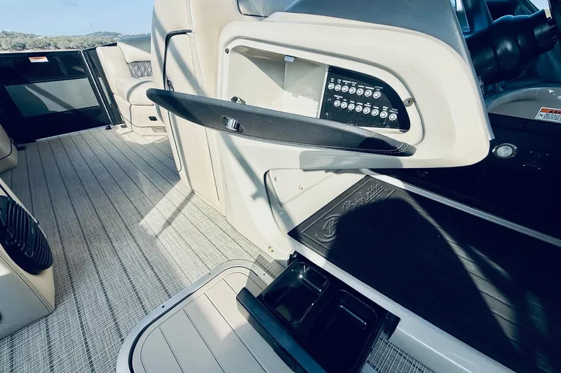 Slide: The Image of 2019 Barletta L23UC boat interior with control panel and seating area. - 26