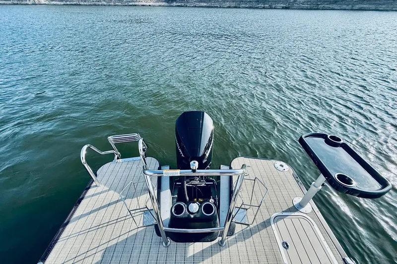 Slide: The Image of 2019 Barletta L23UC pontoon boat with motor on calm water. - 29