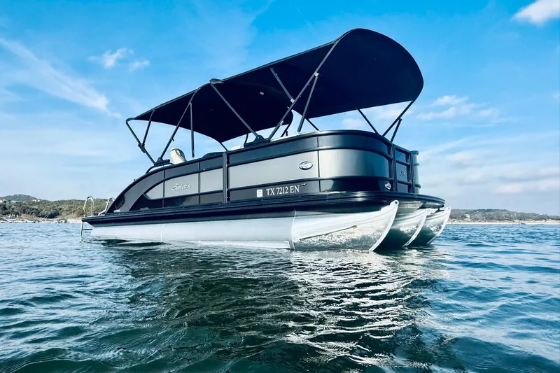 Slide: The Image of 2019 Barletta L23UC pontoon boat on water under blue sky. - 6