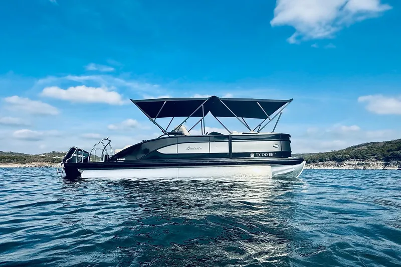 Slide: The Image of 2019 Barletta L23UC pontoon boat on a sunny lake with blue skies. - 7