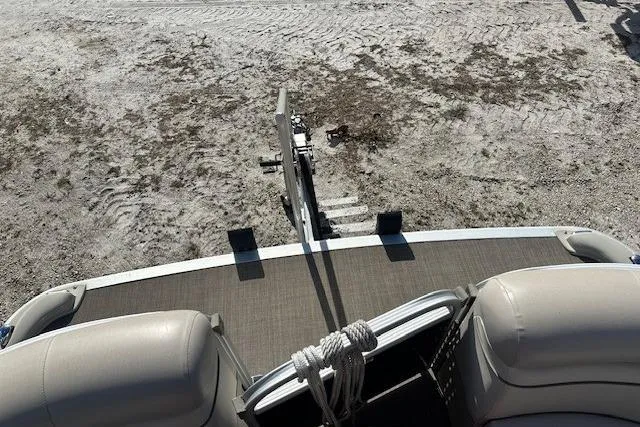 Slide: The Image of 2015 Bennington 21gs boat on sandy terrain, viewed from above. - 18