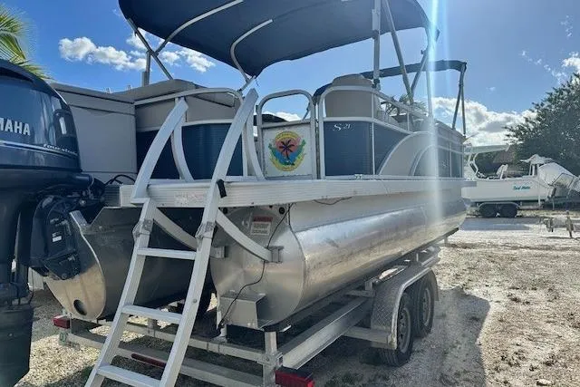 Slide: The Image of 2015 Bennington 21gs pontoon boat with Yamaha outboard motor on trailer. - 2