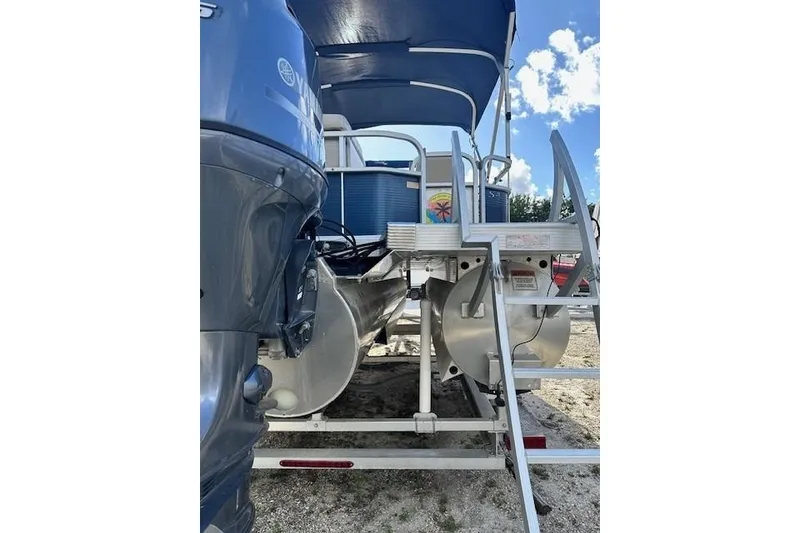 Slide: The Image of 2015 Bennington 21gs pontoon boat on trailer, blue and white, with canopy. - 6