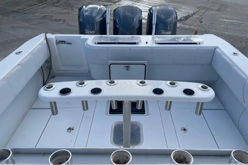 Slide: The Image of 2016 Contender 39 ST boat deck with rod holders and triple Yamaha 300 engines. - 14