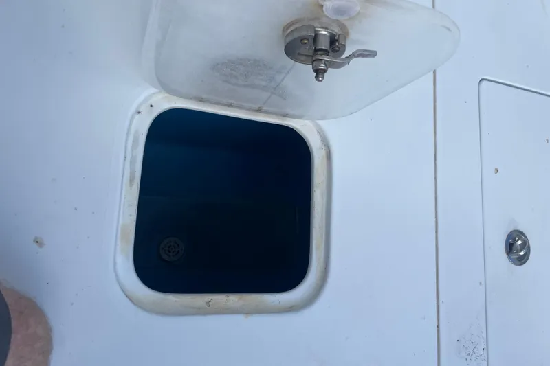 Slide: The Image of Open hatch on 2016 Contender 39 ST boat deck, showing interior compartment. - 15