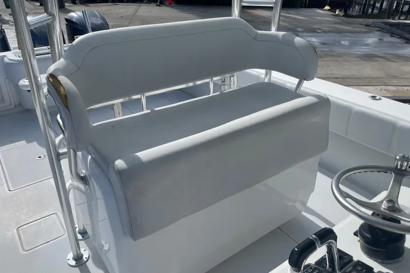 Slide: The Image of 2016 Contender 39 ST boat interior with white seating and steering wheel. - 17