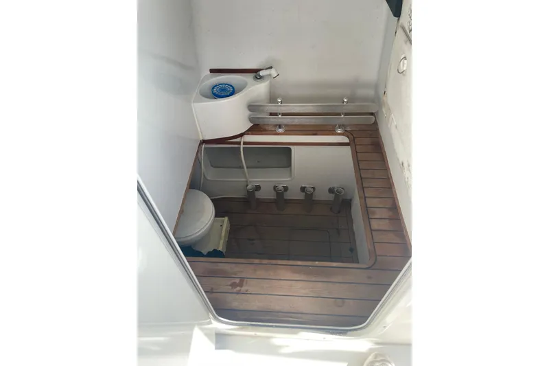 Slide: The Image of 2016 Contender 39 ST boat interior with wooden flooring and compact bathroom setup. - 22