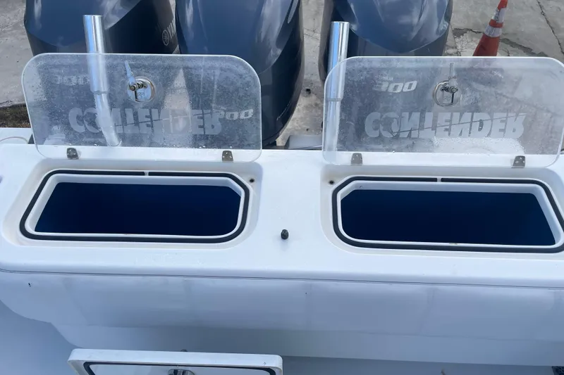 Slide: The Image of Open storage compartments on a 2016 Contender 39 ST boat with Yamaha engines. - 23