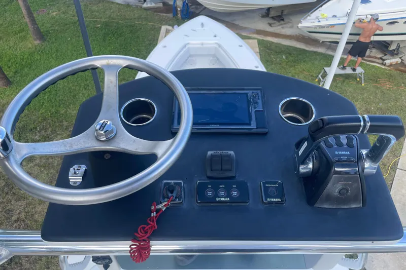 Slide: The Image of 2016 Contender 39 ST boat helm with steering wheel, controls, and navigation system. - 4