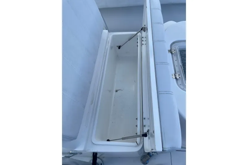 Slide: The Image of Open storage compartment on 2016 Contender 39 ST boat, featuring white cushioned seating. - 8