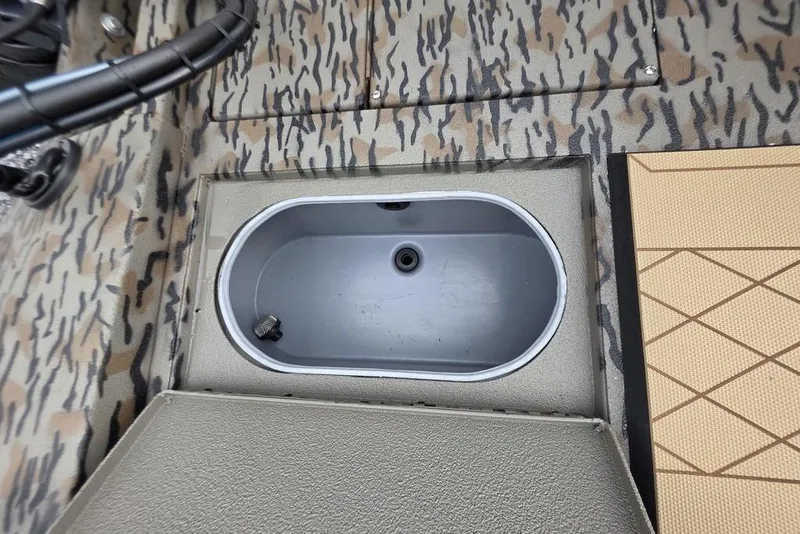 Slide: The Image of 2026 Xpress H190B Bay boat interior with camo pattern and storage compartment. - 12