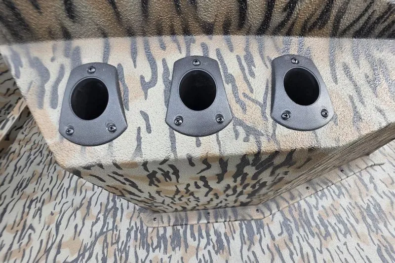 Slide: The Image of 2026 Xpress H190B Bay boat with camo pattern and three rod holders. - 13