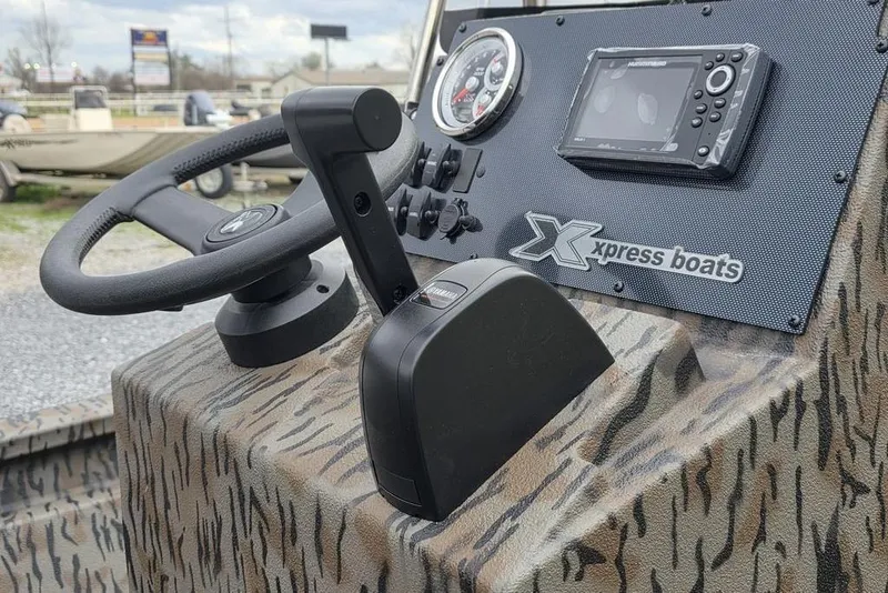 Slide: The Image of 2026 Xpress H190B Bay boat dashboard with steering wheel and control panel. - 14