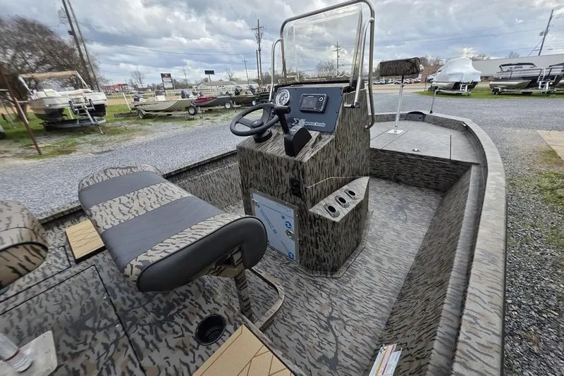 Slide: The Image of 2026 Xpress H190B Bay boat interior with camouflage design, featuring steering console and seating. - 4
