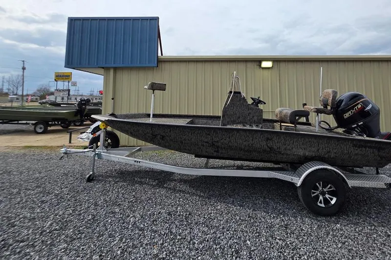 Slide: The Image of 2026 Xpress H190B Bay boat on trailer, parked outside a building. - 8