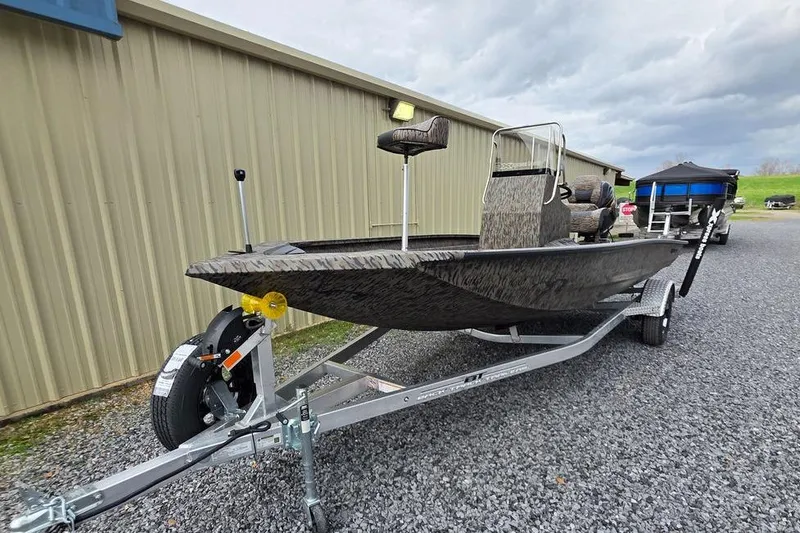 Slide: The Image of 2026 Xpress H190B Bay boat on trailer, parked on gravel near a building. - 9
