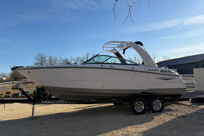 Slide: The Image of 2025 Monterey 278SS Super Sport boat on trailer under clear sky. - 2