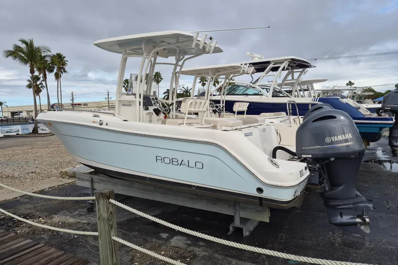 Slide: The Image of 2017 Robalo R222 Center Console boat with Yamaha engine, displayed outdoors. - 2