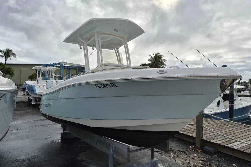 Slide: The Image of 2017 Robalo R222 Center Console boat docked, overcast sky, marina setting. - 3
