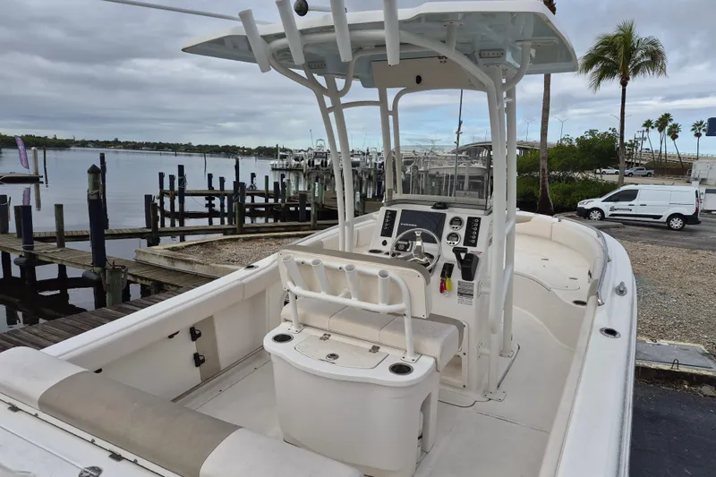 Slide: The Image of 2017 Robalo R222 Center Console boat docked by a marina under cloudy skies. - 5
