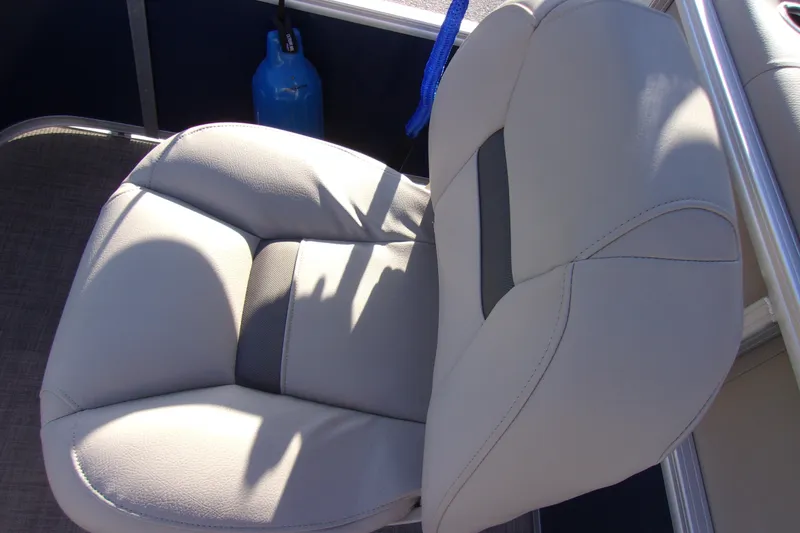 Slide: The Image of 2023 Sun Tracker Bass Buggy 18 DLX boat seat with blue tank in background. - 11