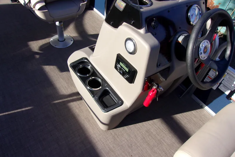 Slide: The Image of 2023 Sun Tracker Bass Buggy 18 DLX console with steering wheel and cup holders. - 12